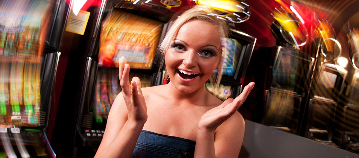 Surprised woman standing in front of slot machines